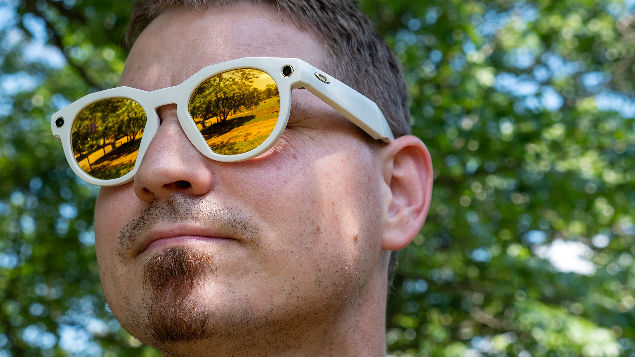 Wearing a pair of warm white limited edition Oakley Meta HSTN smart glasses with PRIZM lenses