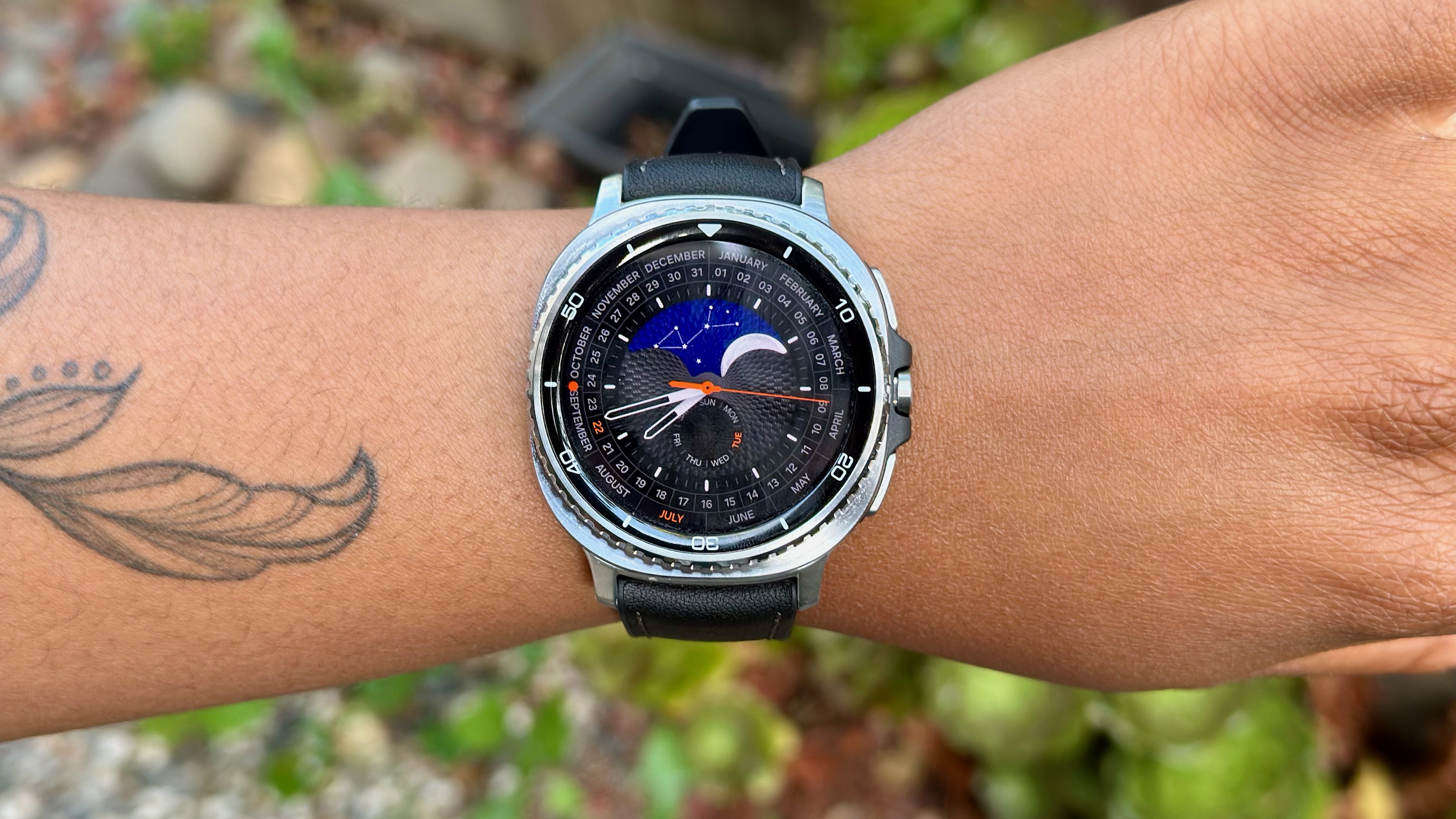 A close-up of the Samsung Galaxy Watch 8 Classic on a woman's wrist showing the Heritage Classic watch face.
