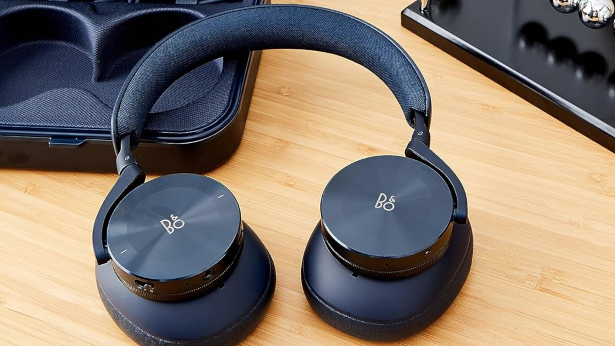 A pair of wireless headphones on a desk