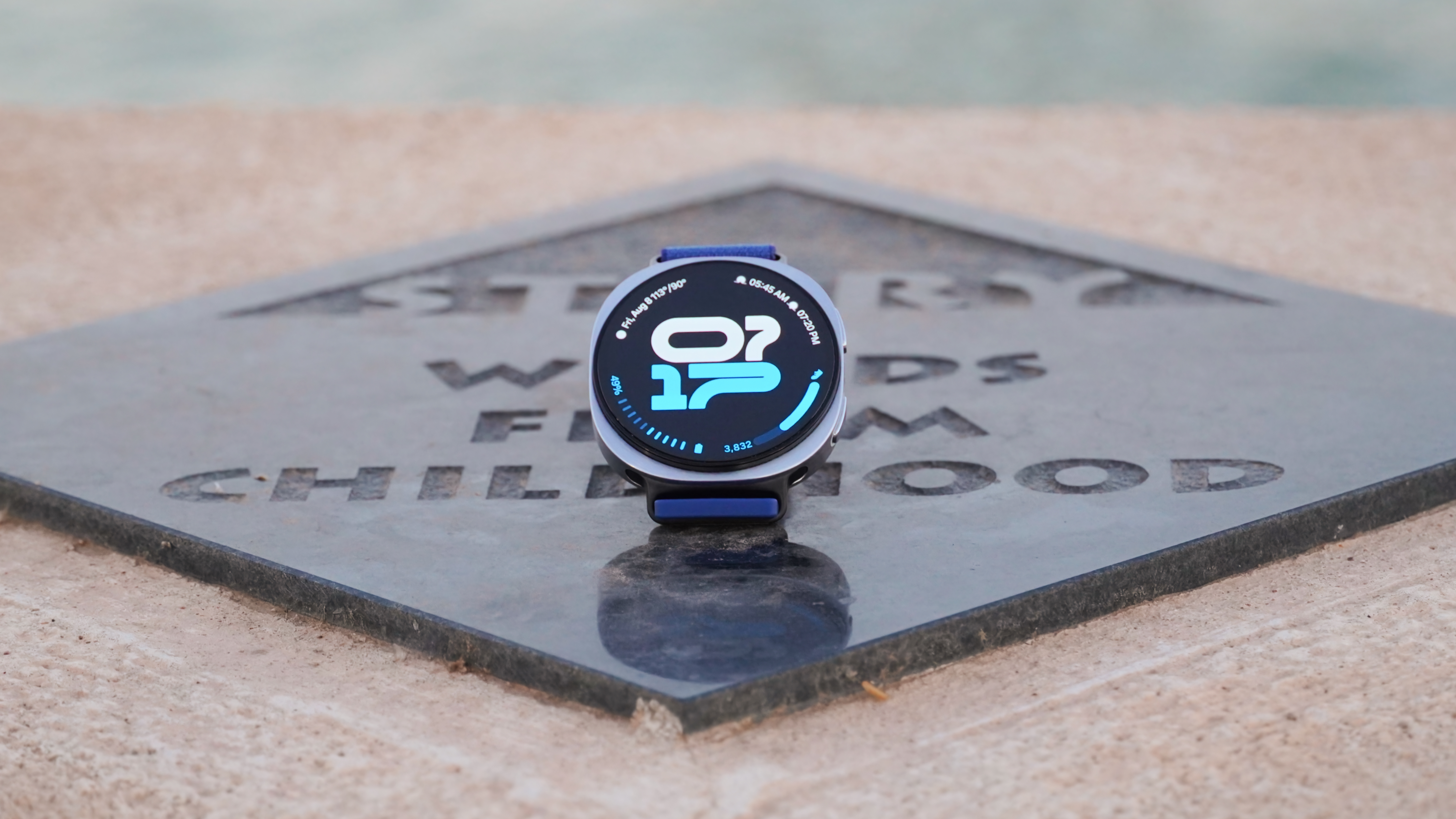 The Samsung Galaxy Watch 8 showing an athletic watch face on a plaque.